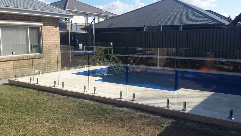Swimming pool with a glass fence — Balustrading in Unanderra NSW