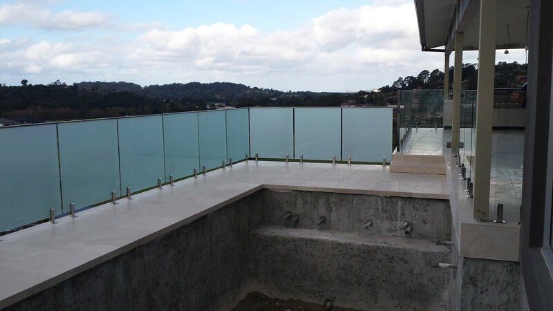Swimming pool without water with a glass fence — Balustrading in Unanderra NSW