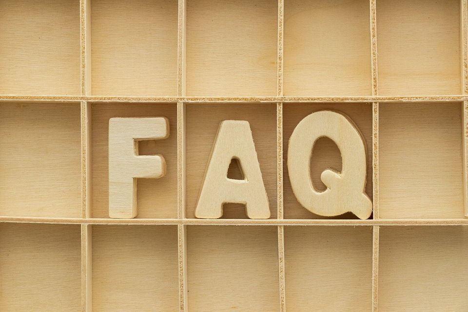 the letters FAQ in wooden boxes