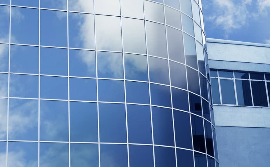 A Building With a Lot of Windows Against a Blue Sky — TSR Tinting & Frosting In Caloundra West, QLD