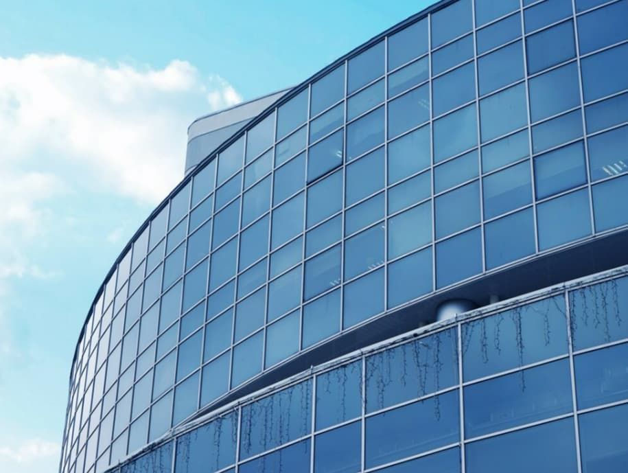 A Building With a Lot of Windows and a Blue Sky in the Background — TSR Tinting & Frosting In Caloundra West, QLD