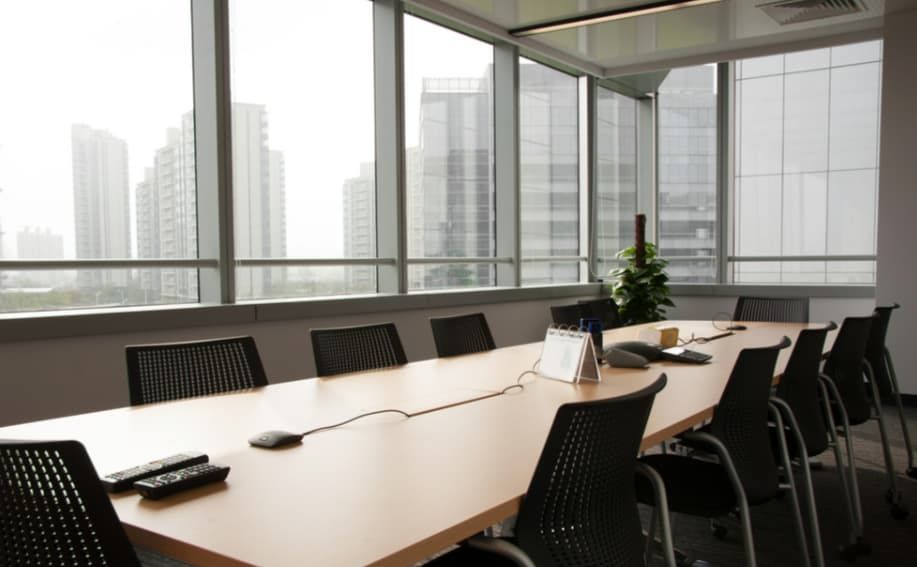 A Conference Room With a Long Table and Chairs — TSR Tinting & Frosting In Caloundra West, QLD