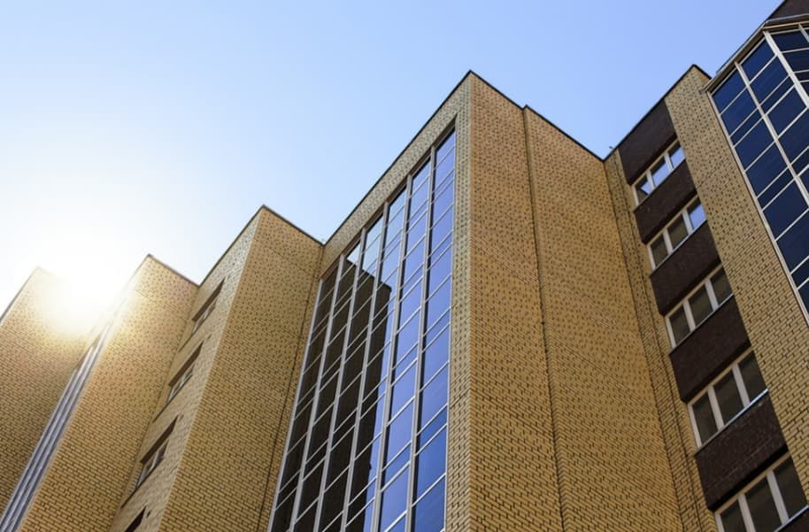 The Sun is Shining Through the Windows of a Tall Building — TSR Tinting & Frosting In Caloundra West, QLD