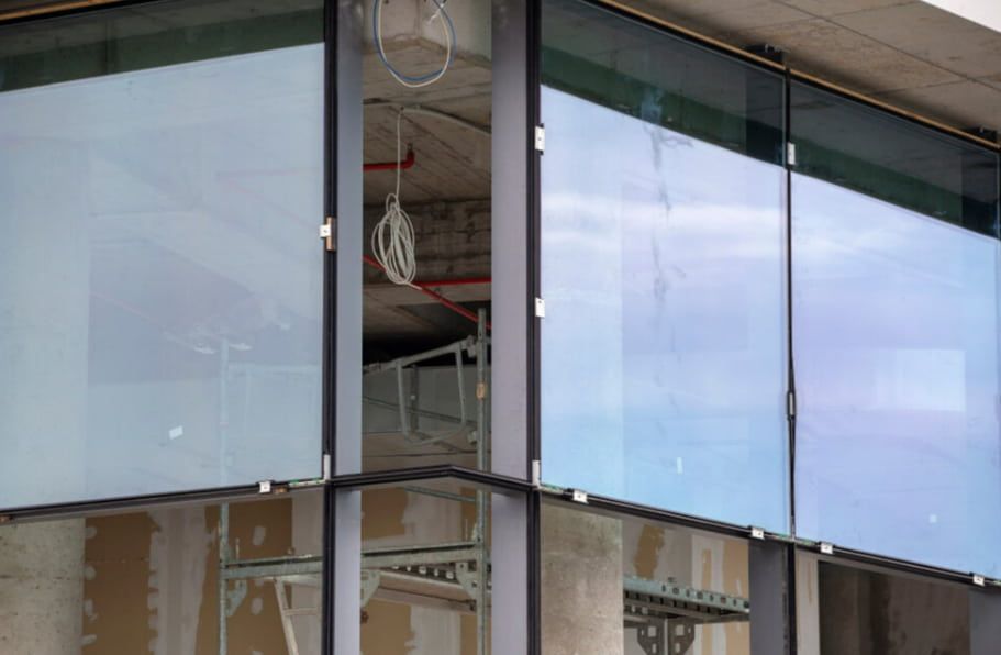 A Building Under Construction With a Lot of Windows and Scaffolding — TSR Tinting & Frosting in Noosa, QLD