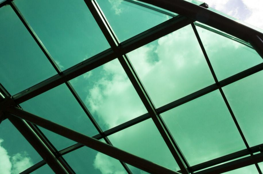 A Building With a Lot of Windows and Trees in Front of It — TSR Tinting & Frosting in Caloundra, QLD