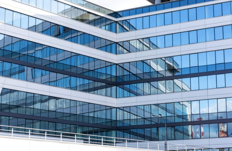 A Large Building With a Lot of Windows and a Bridge in Front of It — TSR Tinting & Frosting in Caloundra, QLD