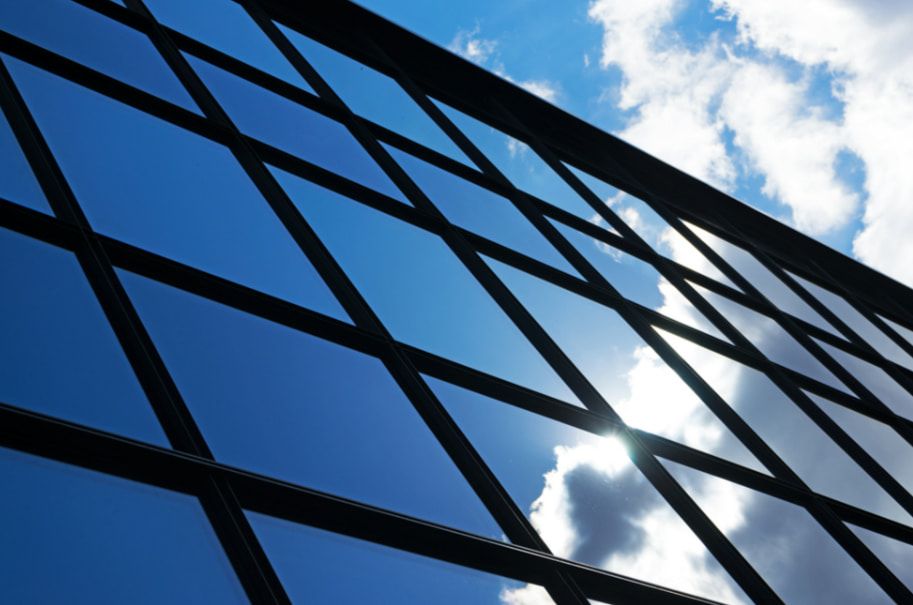 A Large Building With a Lot of Windows on a Sunny Day — TSR Tinting & Frosting in Caloundra, QLD