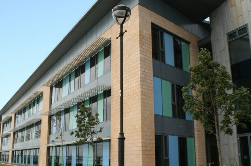 A Large Building With a Street Light in Front of It — TSR Tinting & Frosting in Maroochydore, QLD