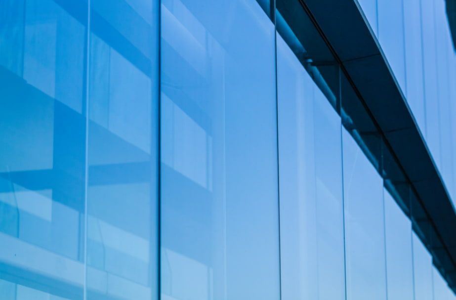 A Close Up of a Blue Glass Building — TSR Tinting & Frosting In Caloundra West, QLD