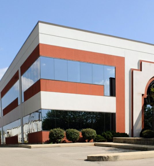 A Large White and Red Building With a Lot of Windows — TSR Tinting & Frosting in Maroochydore, QLD