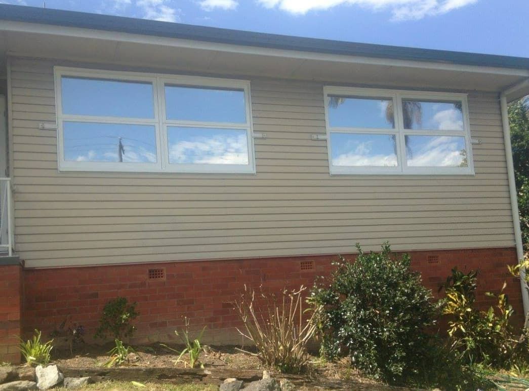 A House With a Lot of Windows and a Blue Sky in the Background — TSR Tinting & Frosting In Caloundra West, QLD