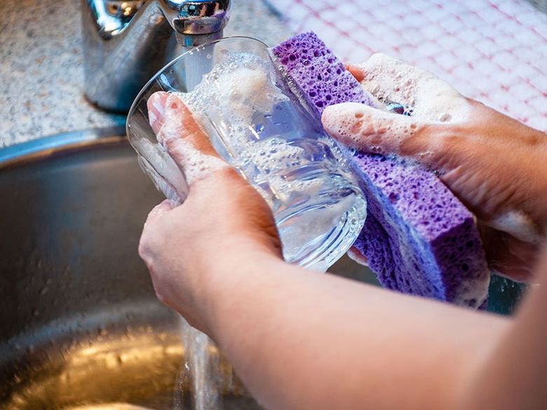Hand Washing The Drinking Glass — Martinez, CA — Ernie’s Plumbing & Sewer Service