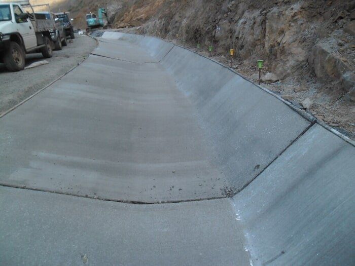 A Truck Is Parked On The Side Of A Road Next To A Concrete Curb — TP Concreting In Warilla, NSW