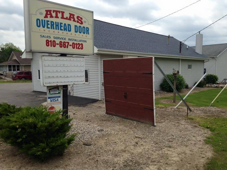 A sign that says atlas overhead door on it