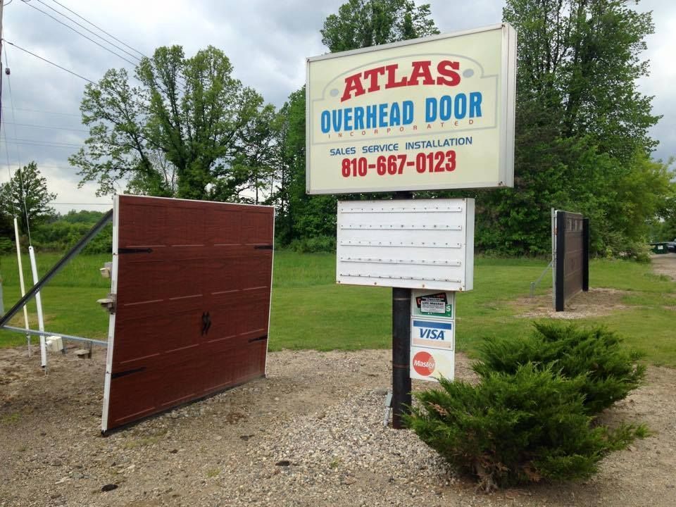 A sign that says atlas overhead door on it