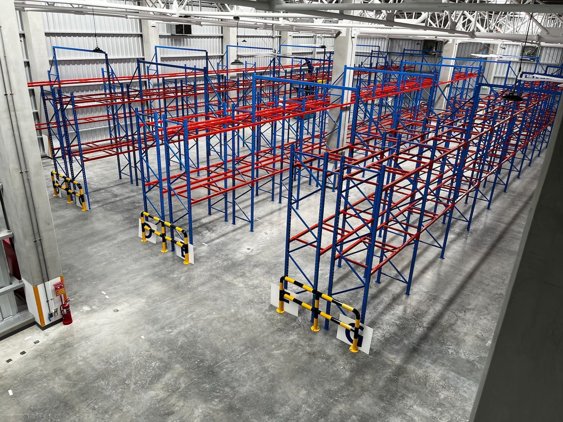 Overhead view of red and blue metal pallet racks