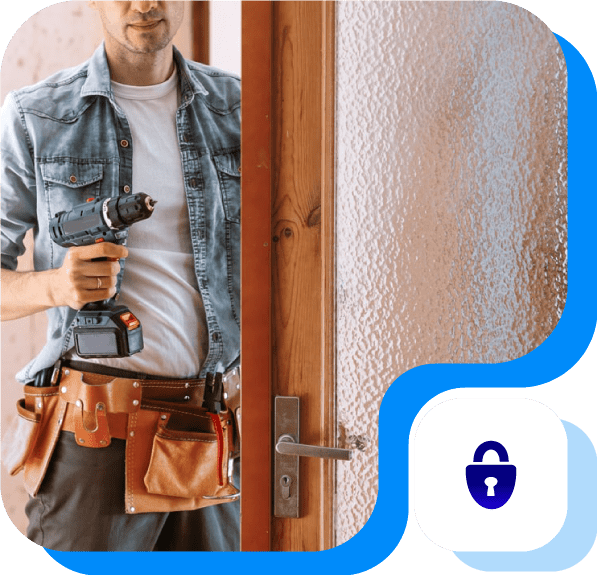 A locksmith technician holding a drill next to a glass and wooden door.