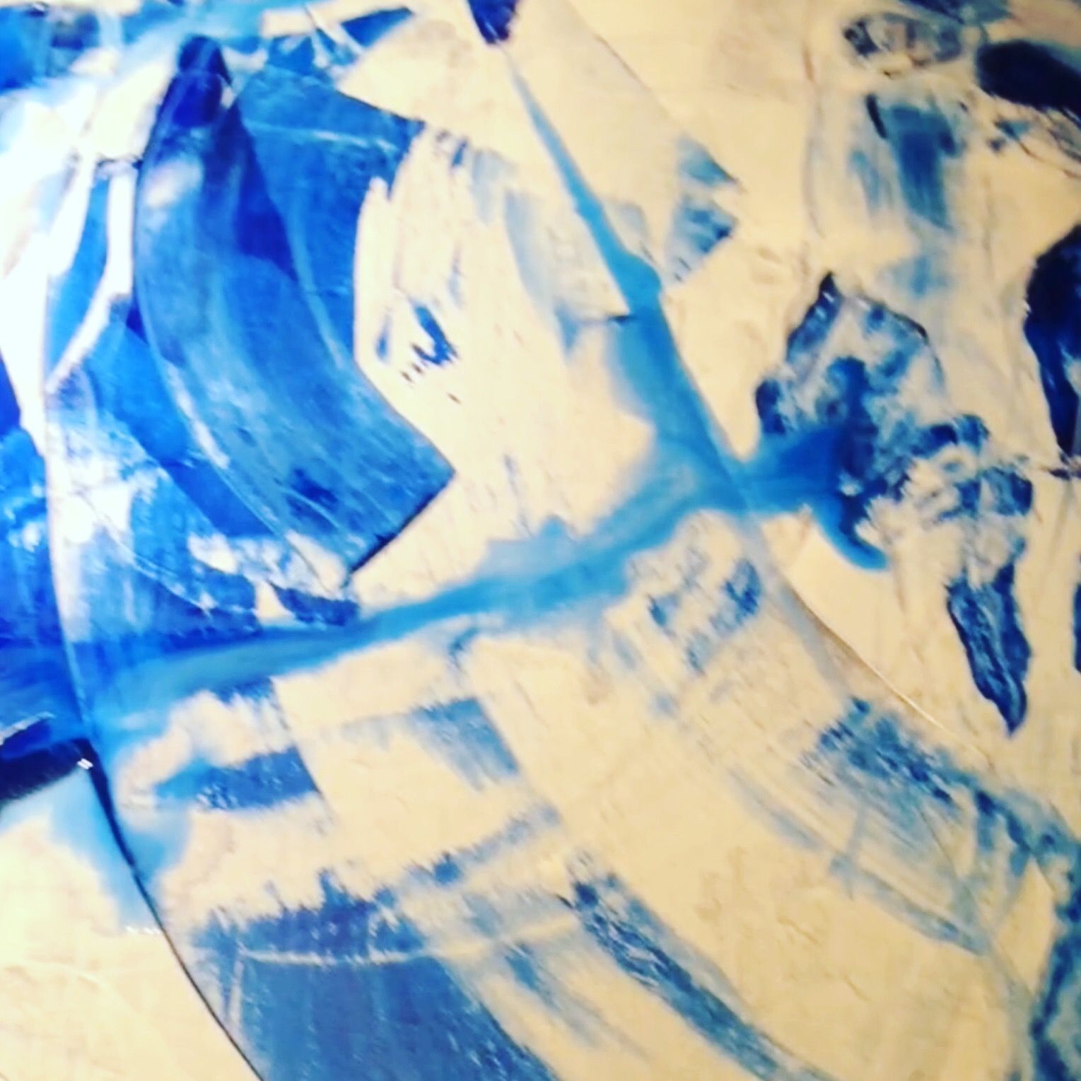 A close up of a blue and white painting