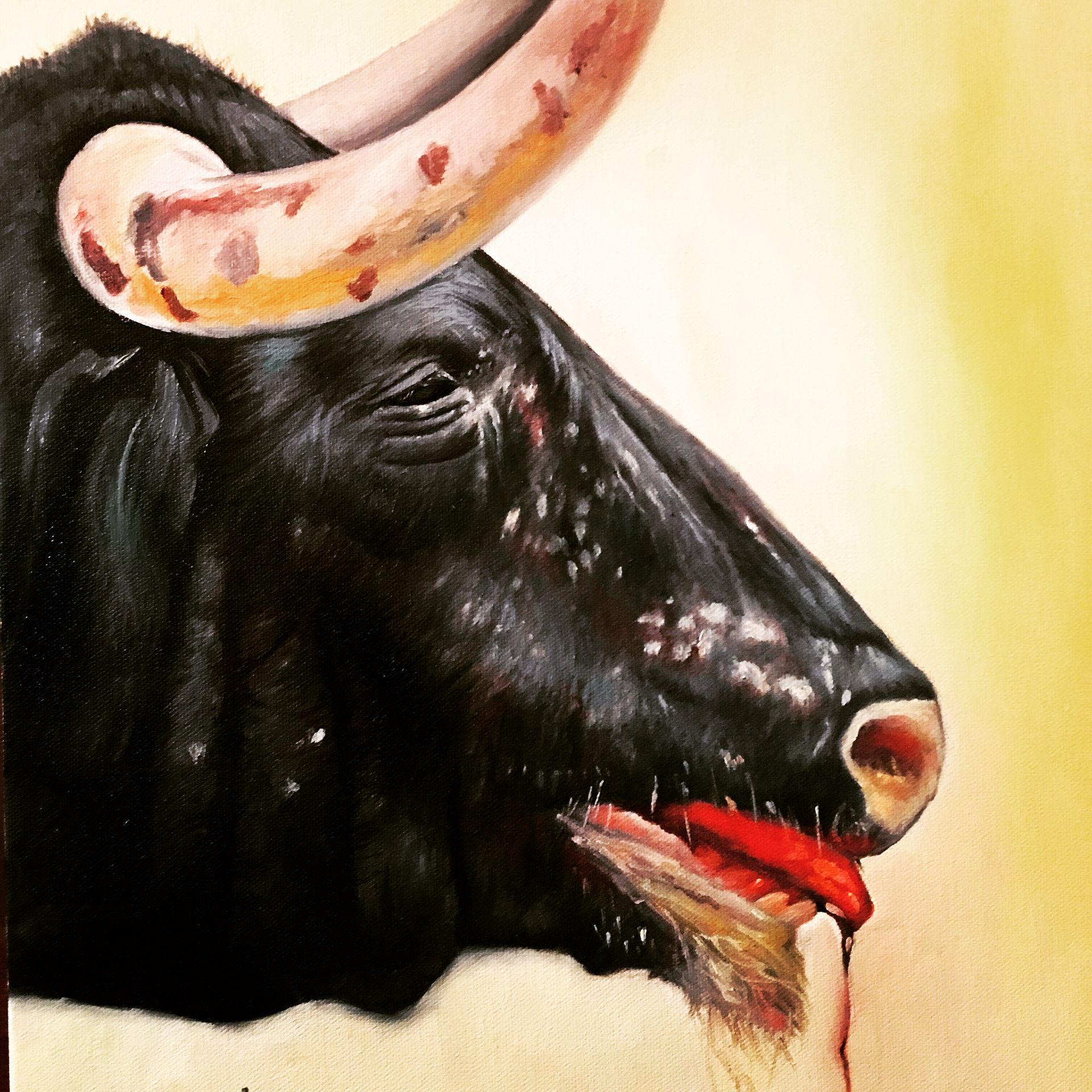 A painting of a bull with its tongue out