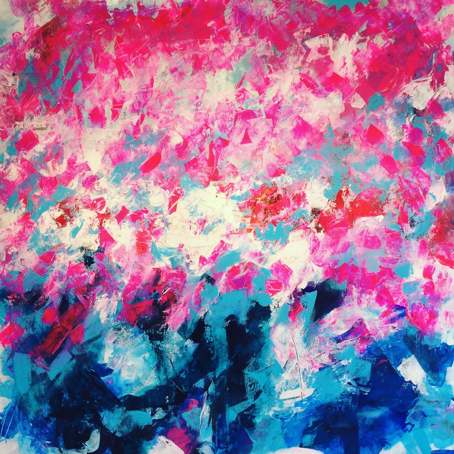 A close up of a colorful painting with pink and blue