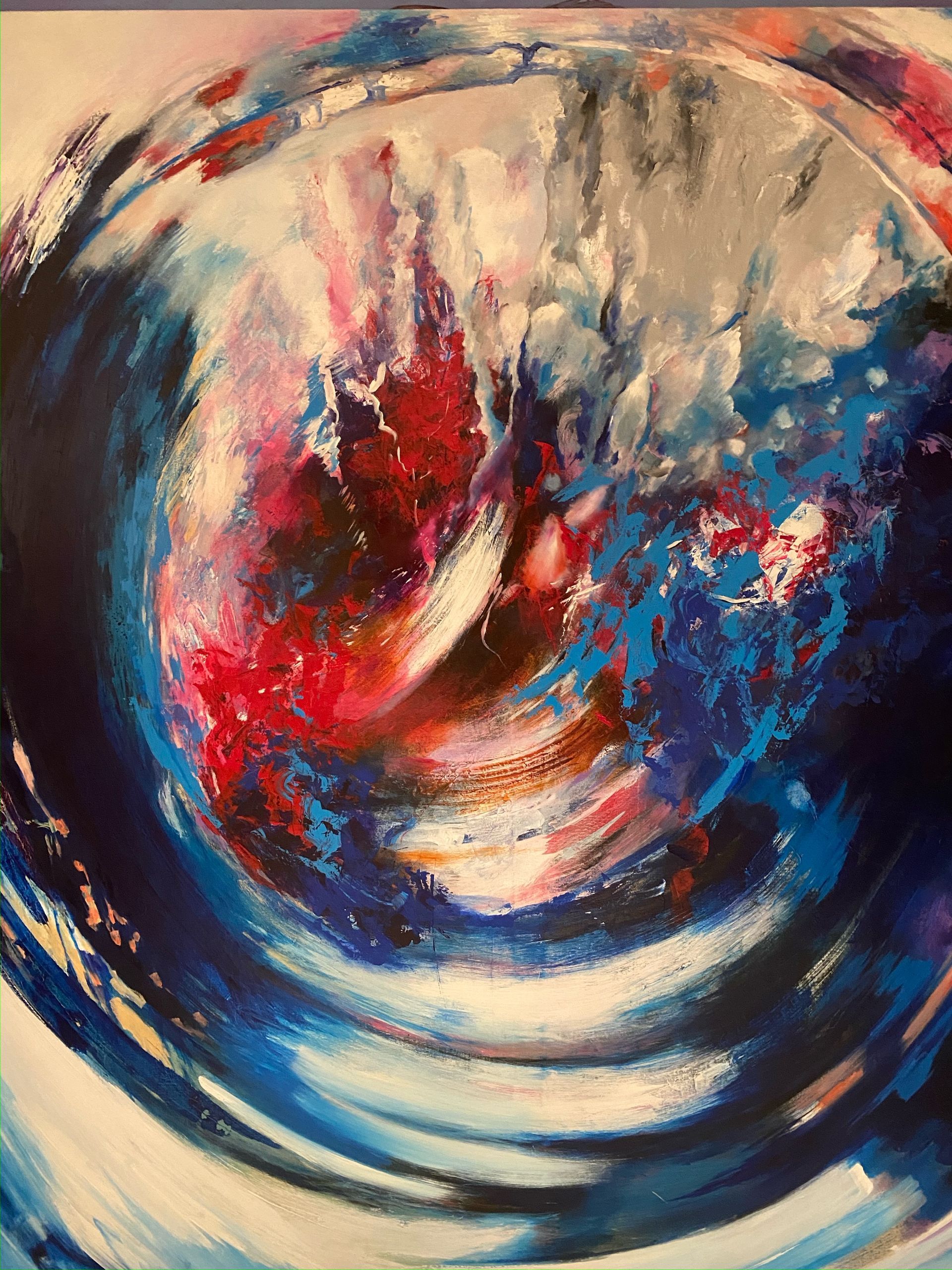 A close up of a painting of a blue and red swirl
