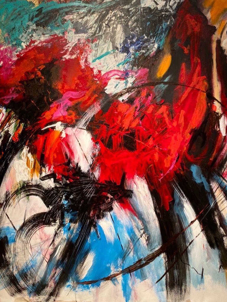 A close up of a colorful painting on a wall.