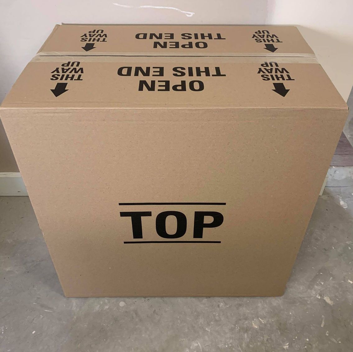 A cardboard box with the word top on it