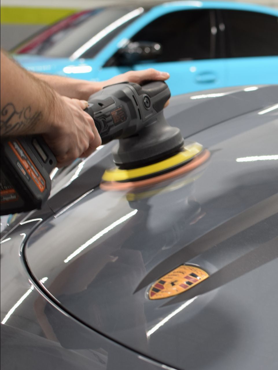 A car wheel is being cleaned with soap and water