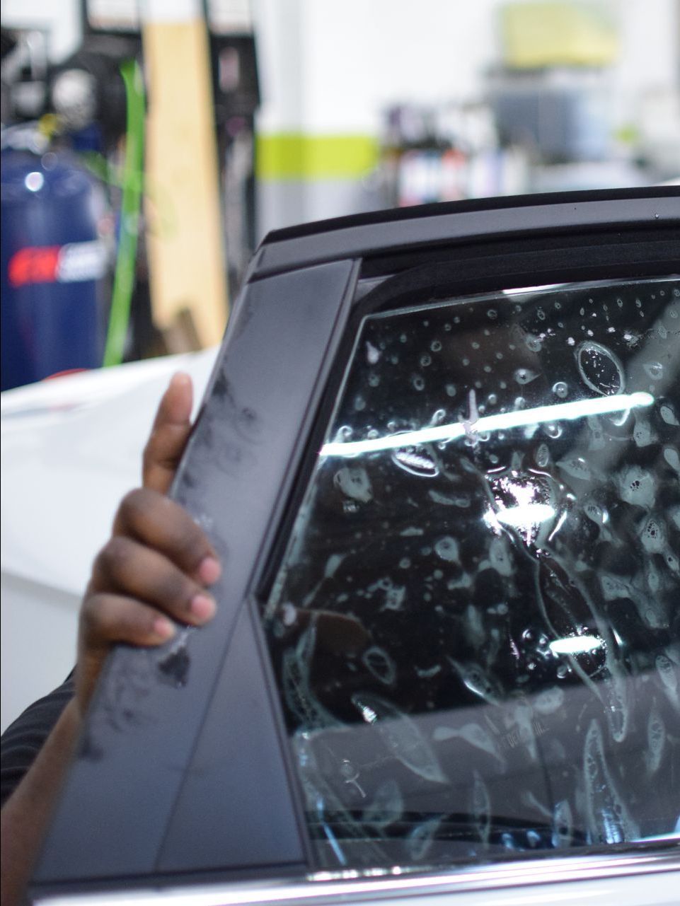 A close up of a car window with a sticker on it.