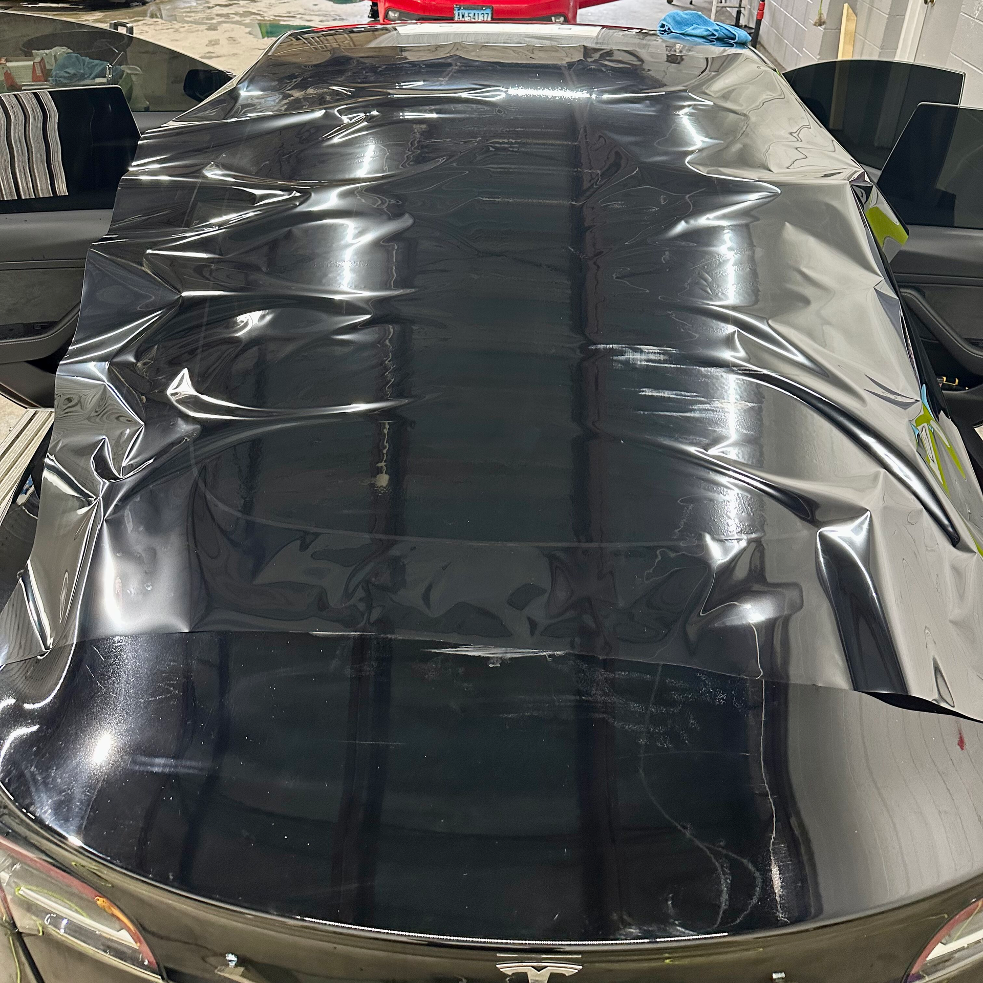 The roof of a tesla model s is covered in black plastic.
