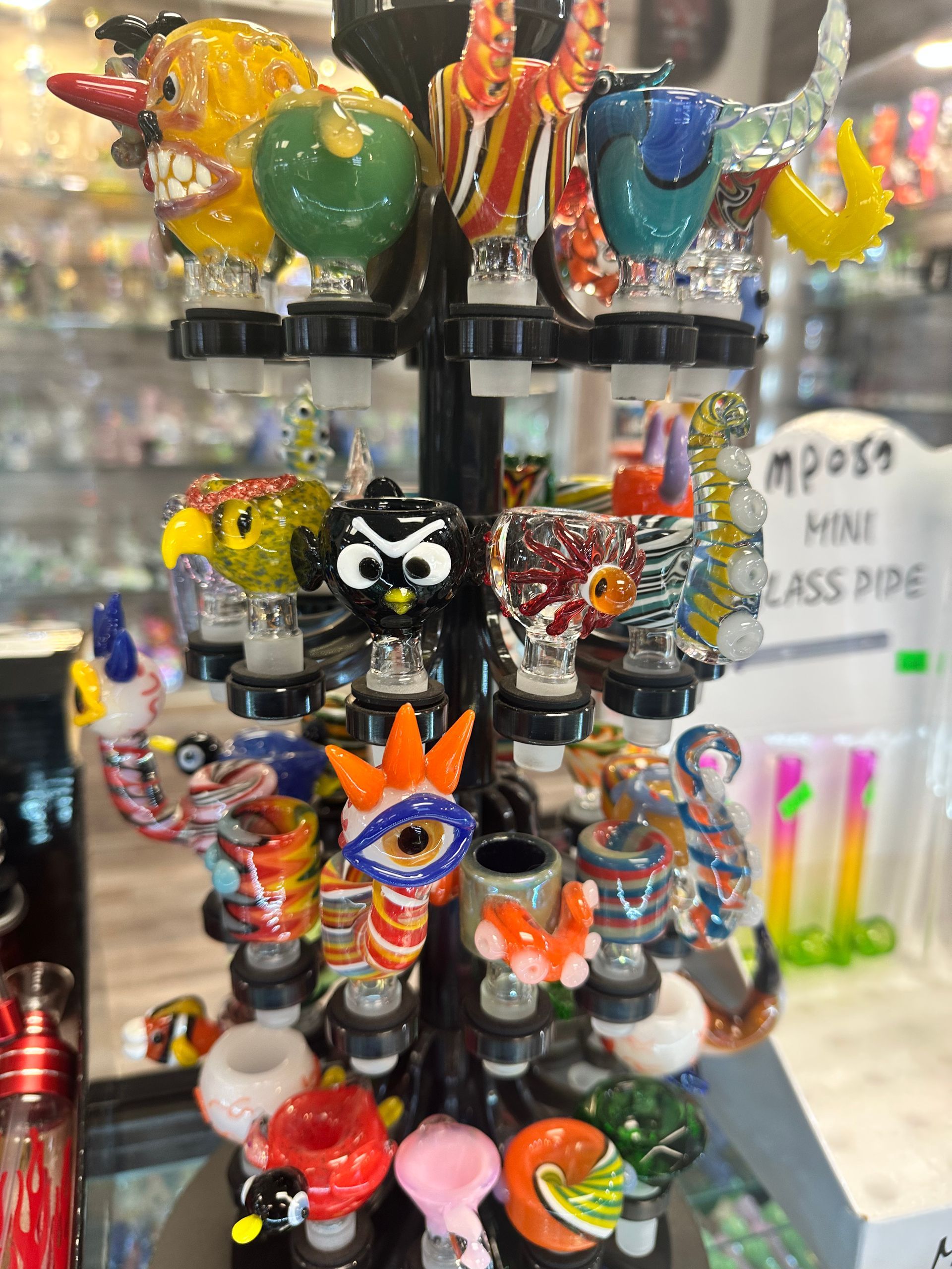 A display of colorful glass pipes in a store.