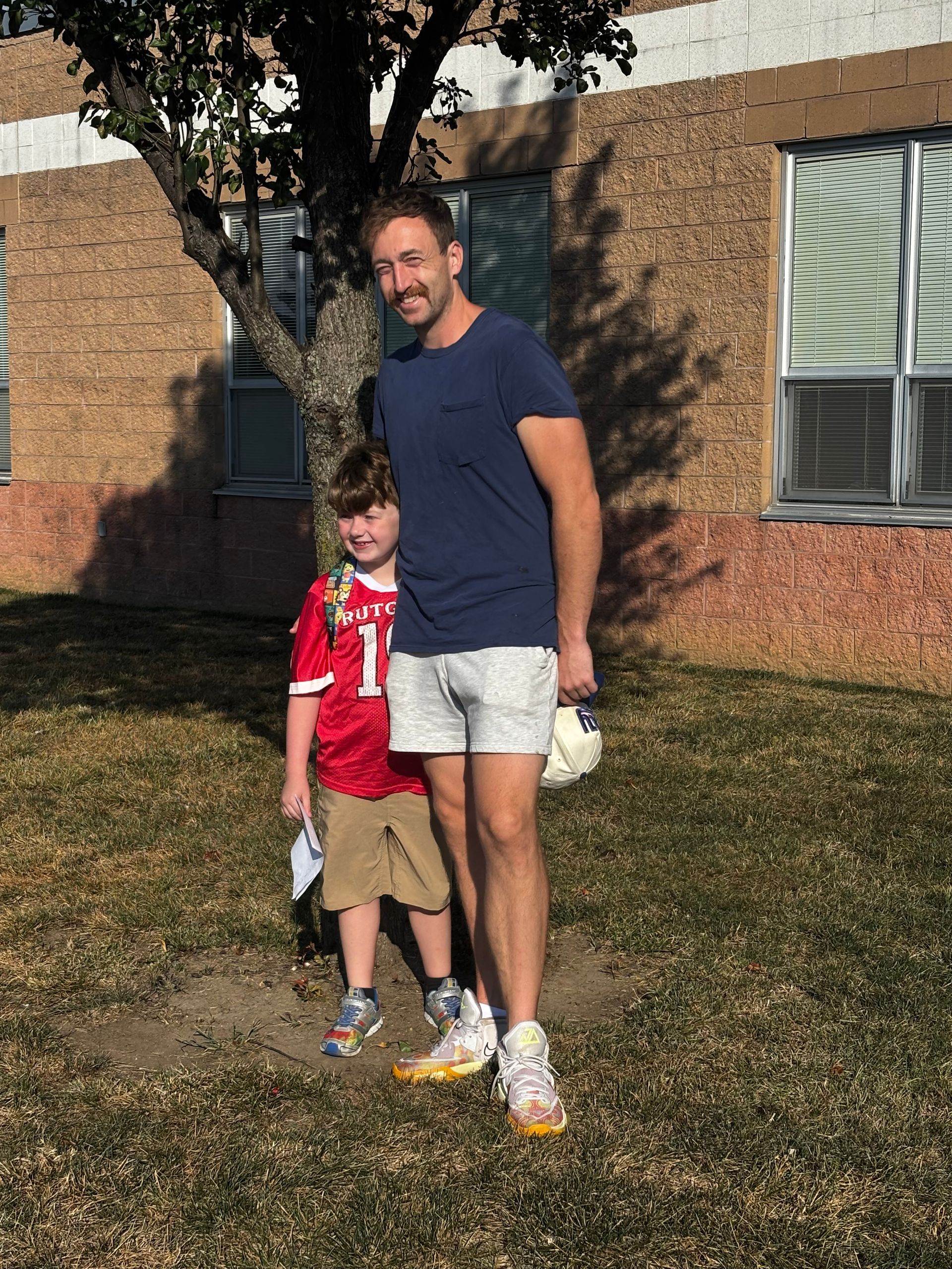 A man with a beard is wearing a blue hoodie