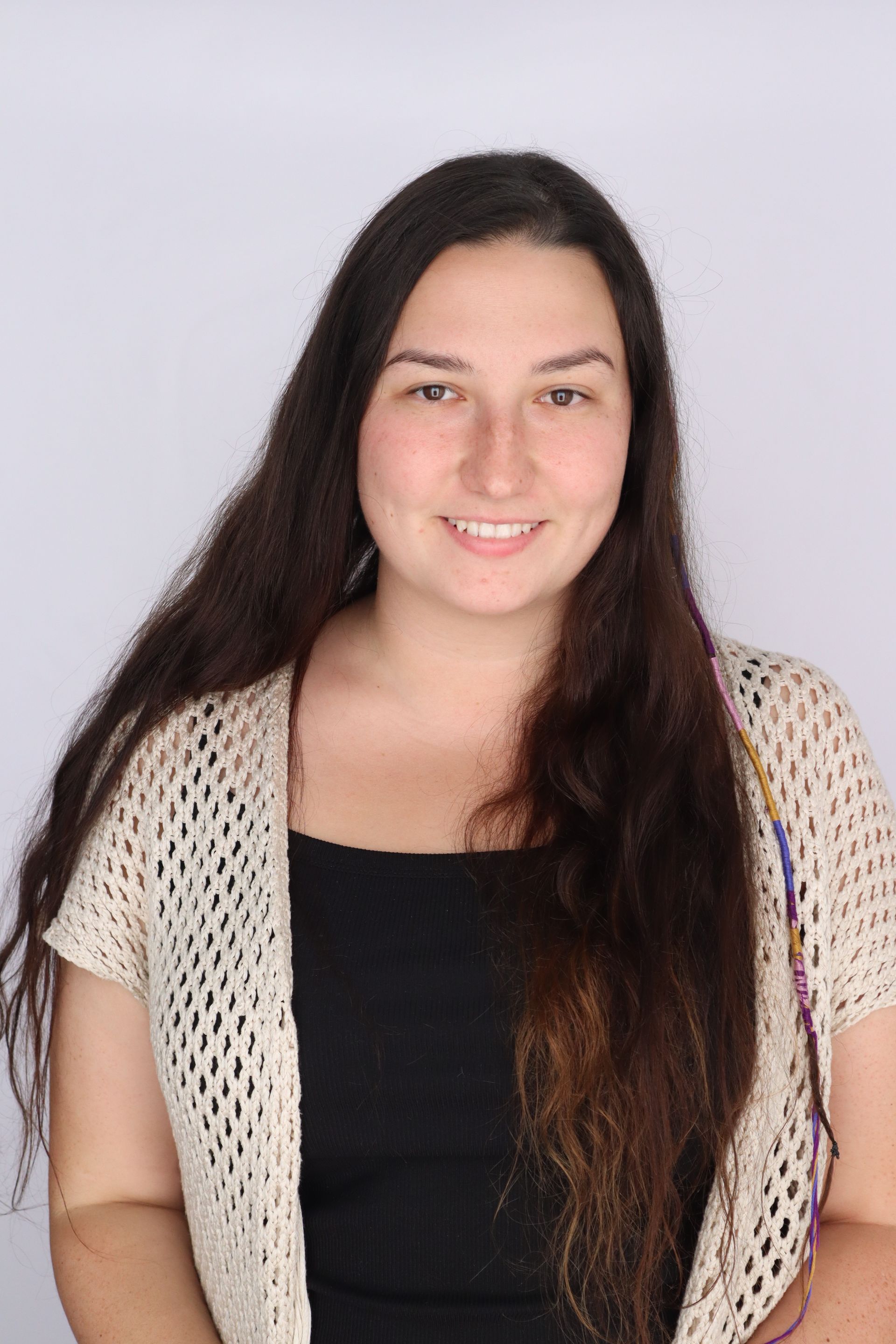 A woman wearing a denim jacket and green glasses