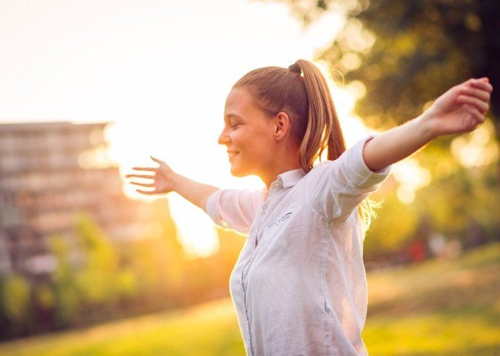 A woman spreading her arms, feeling free
