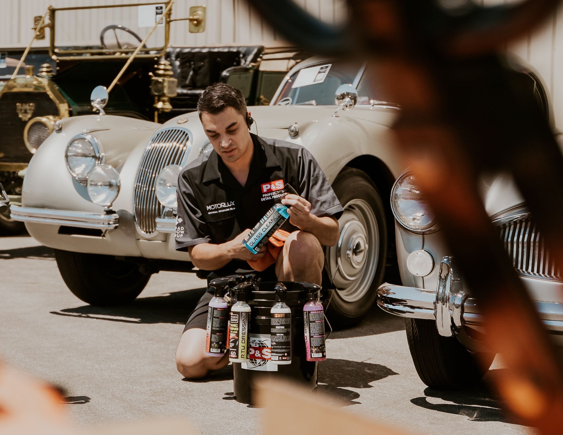 Full Detailing - A man is washing a car.