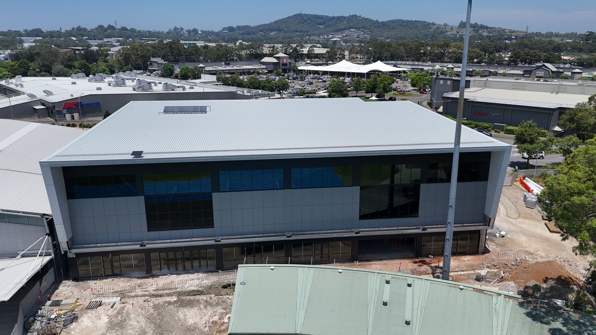 An aerial view of a building under construction in a city.