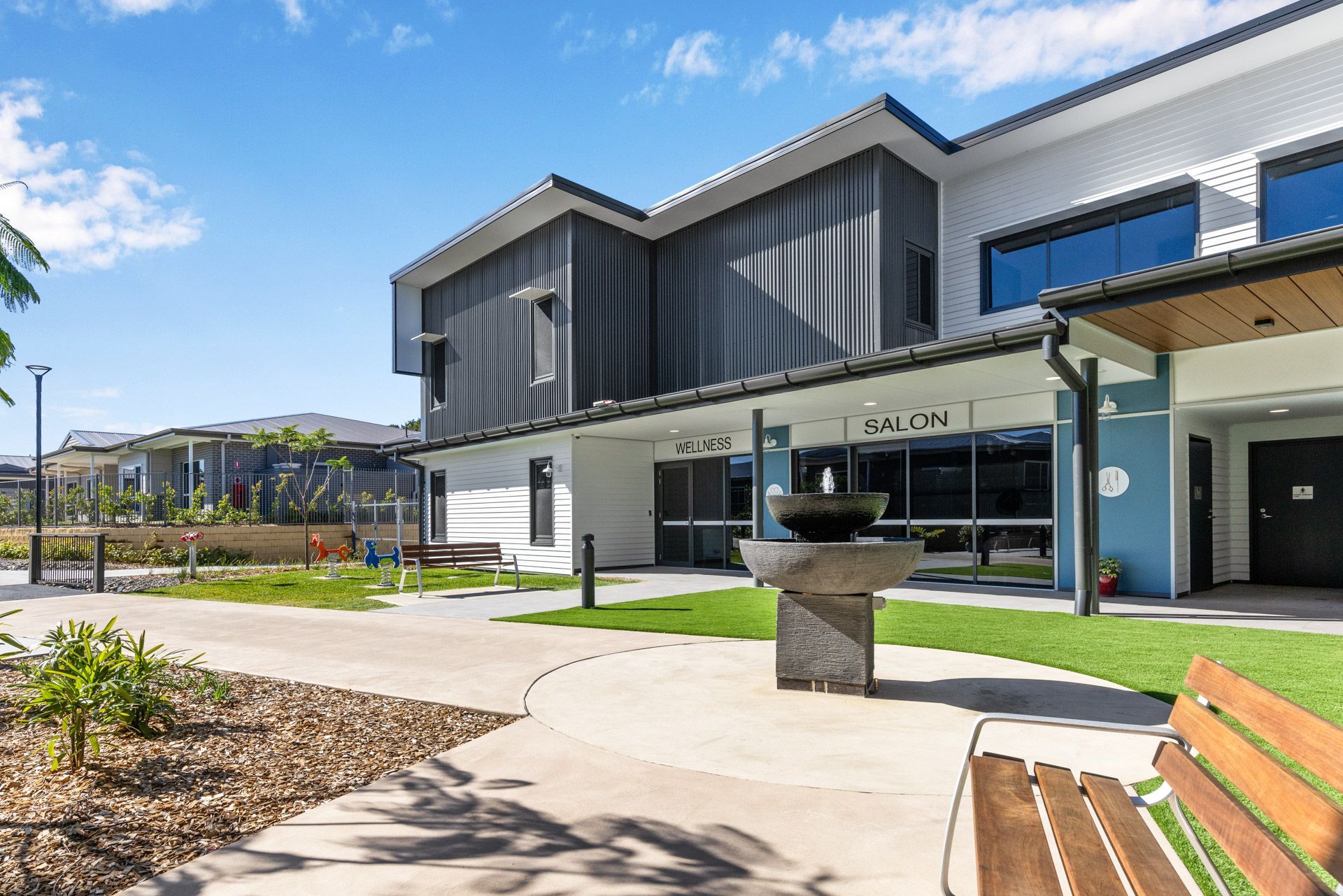 A large building with a bench in front of it.