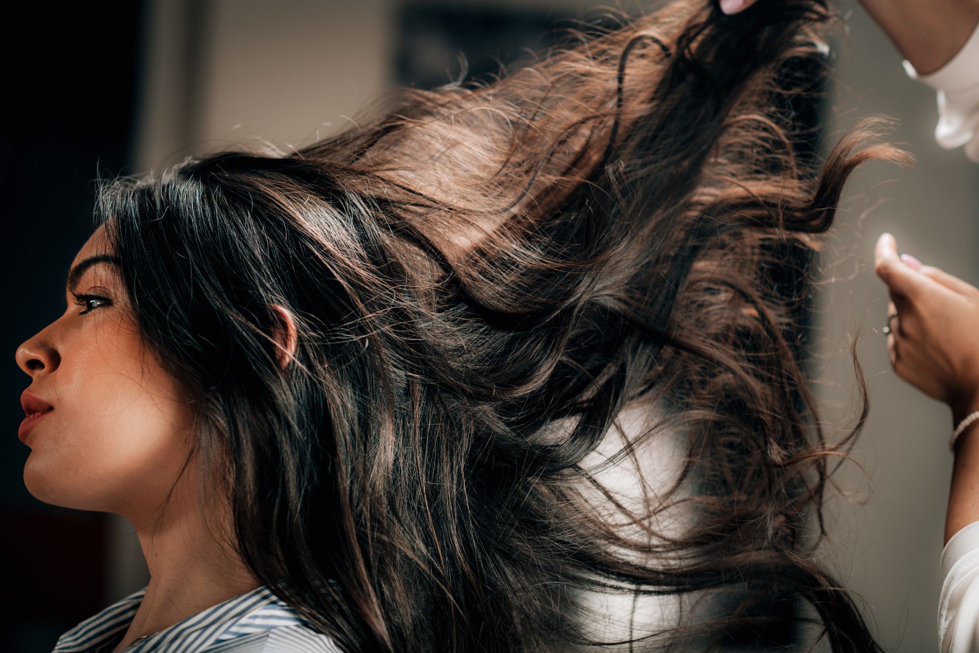 Beautiful hairstyle of young woman, showcasing professional techniques at a hair salon.