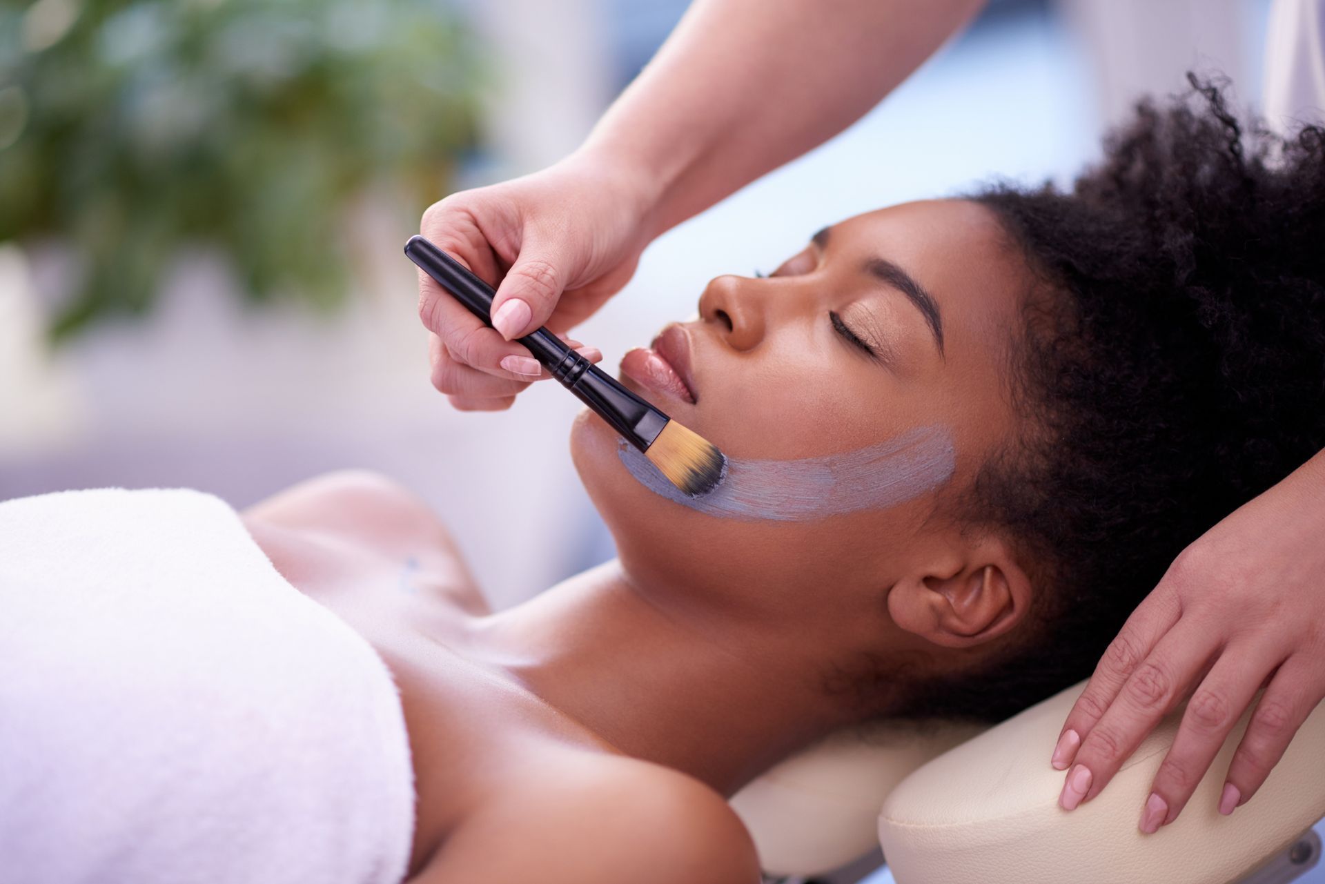 A young woman getting a European facial at a beauty spa A young woman getting a European facial at a beauty spa