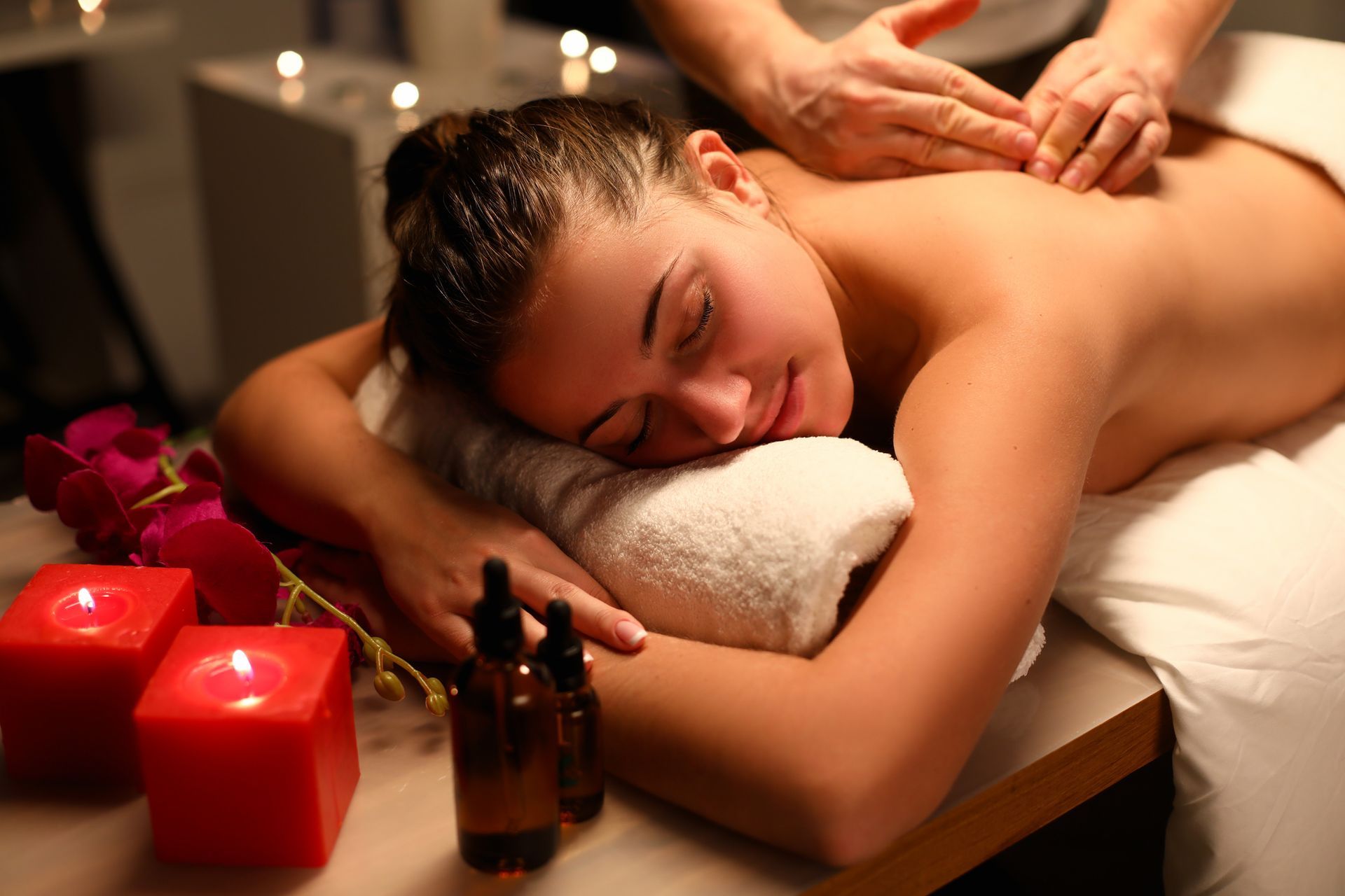 Girl relaxed lying massage, near candles and oil.