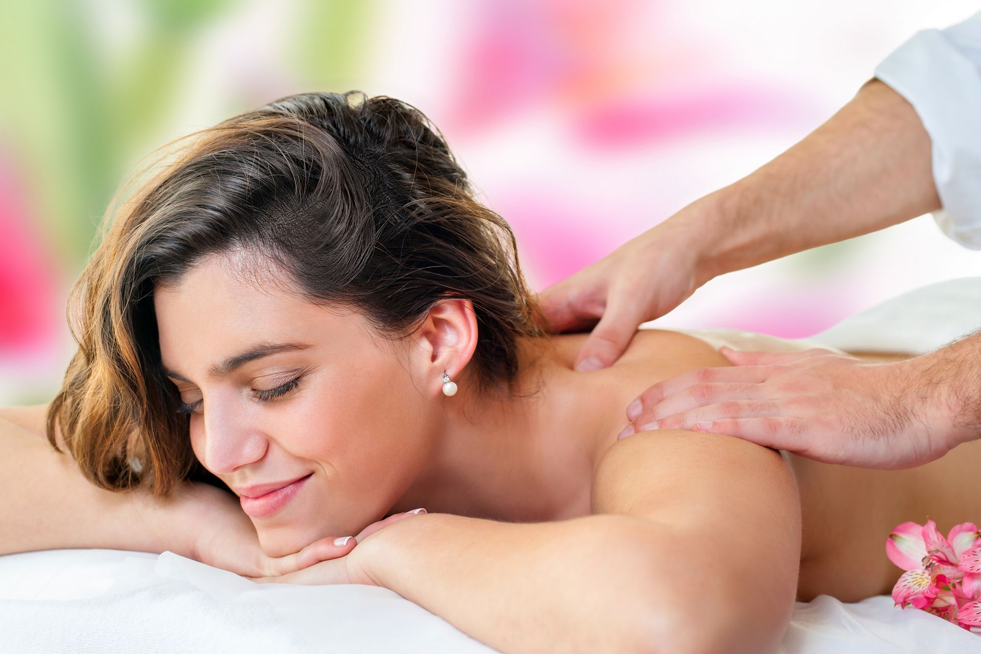Picture of a woman getting a massage as part of a package of spa services she acquired Picture of a woman getting a massage as part of a package of spa services she acquired