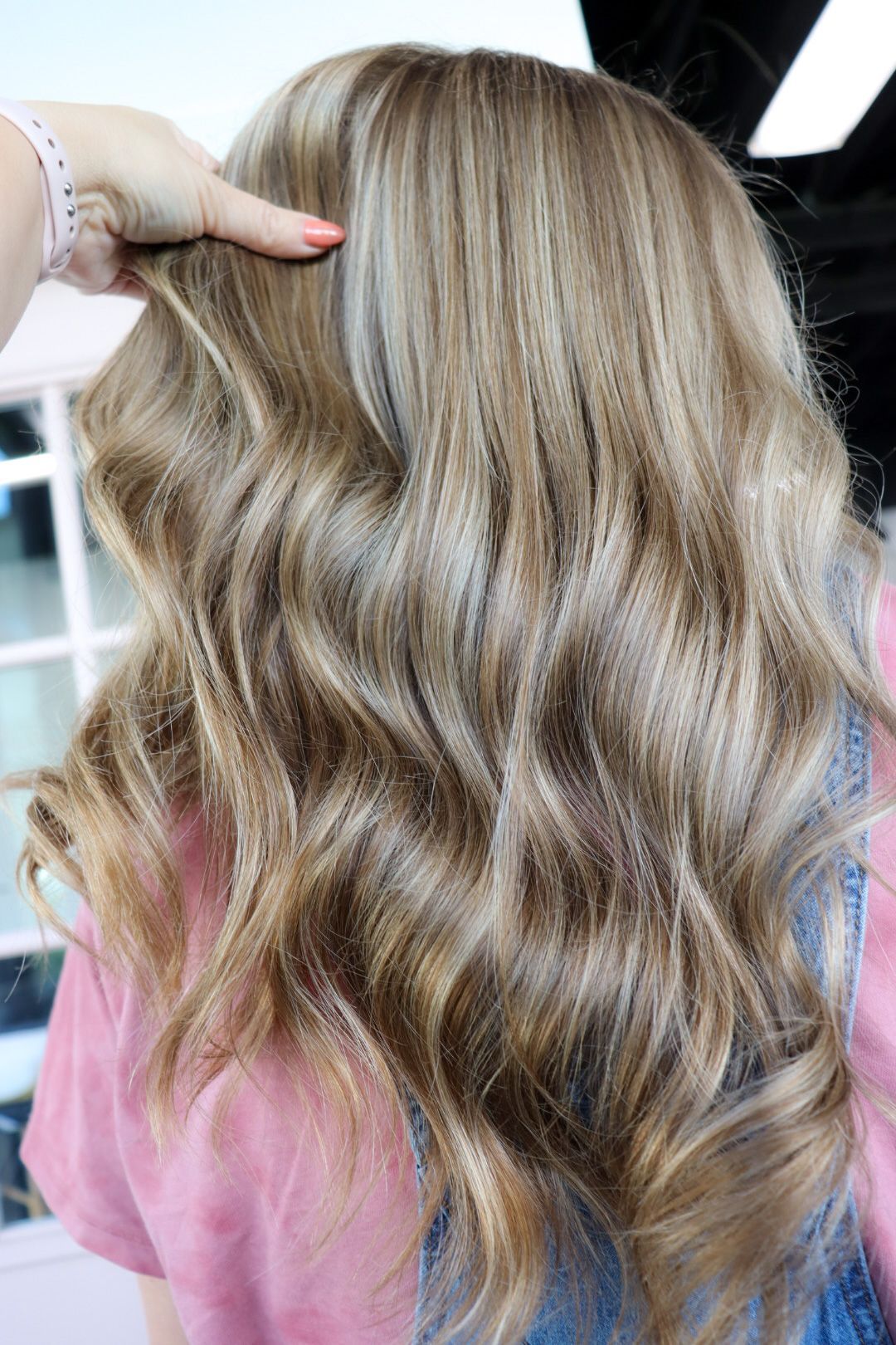 A woman is getting her hair done at a salon.