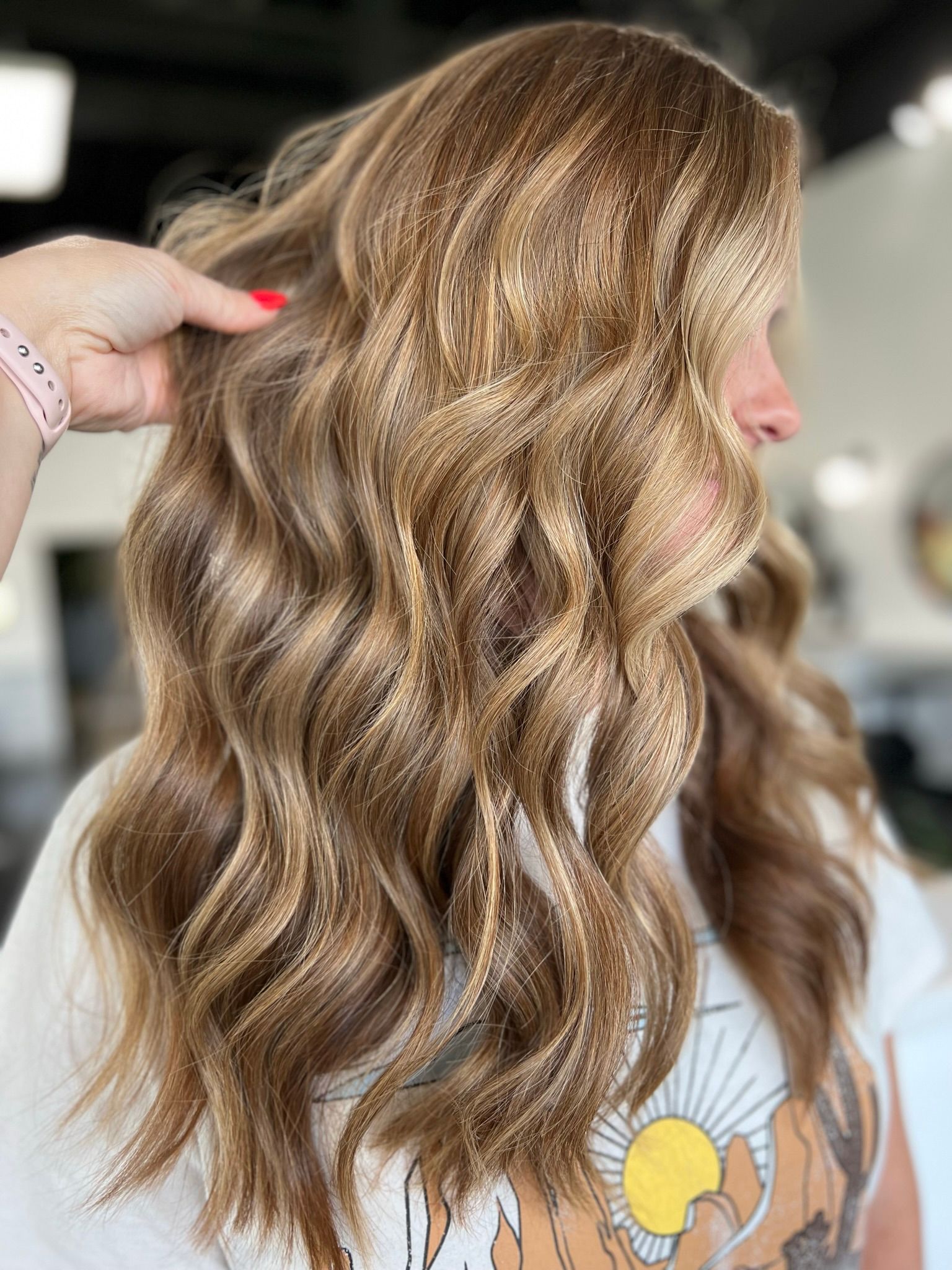 A woman is getting her hair done at a salon.
