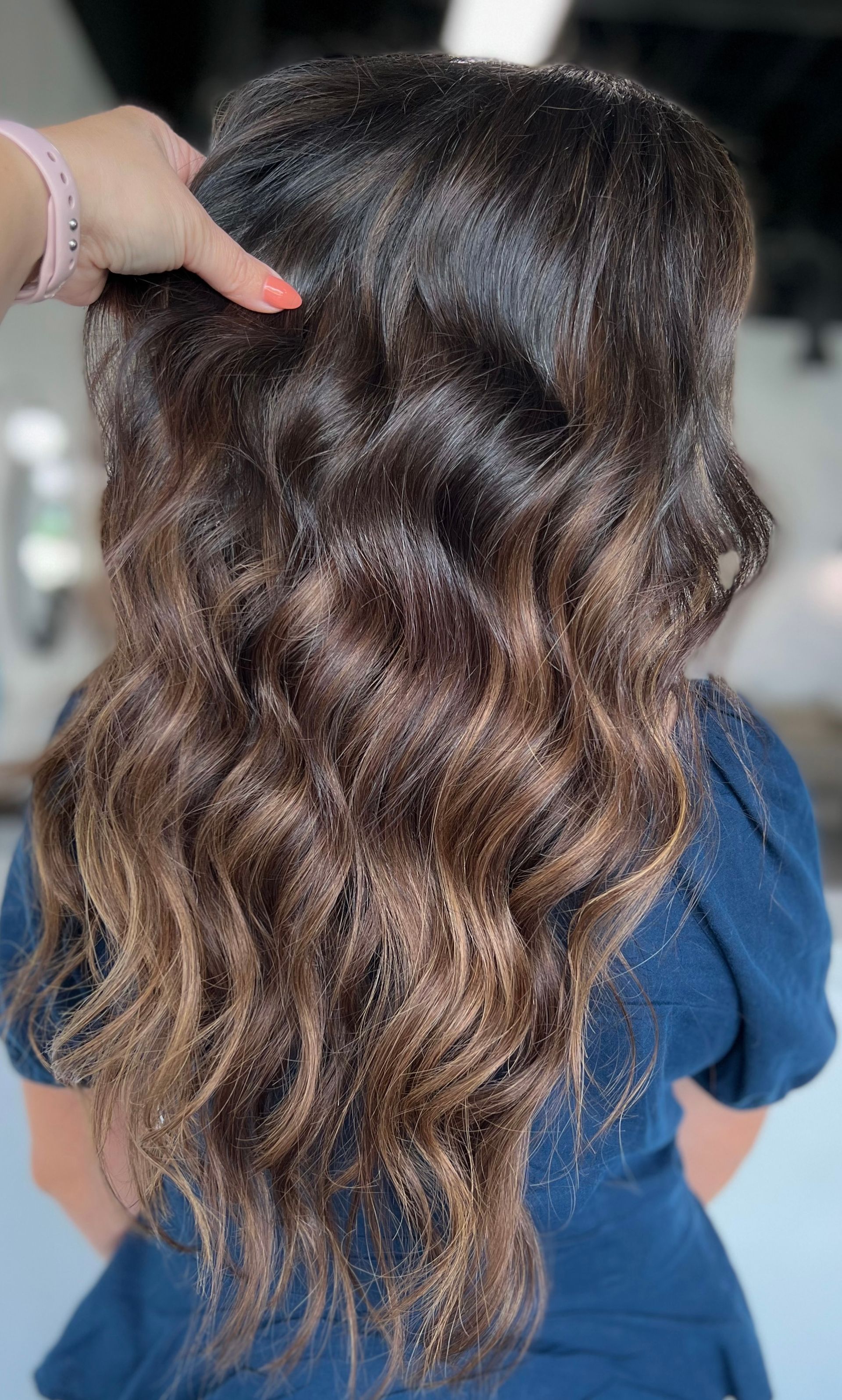 A woman is getting her hair done in a salon.