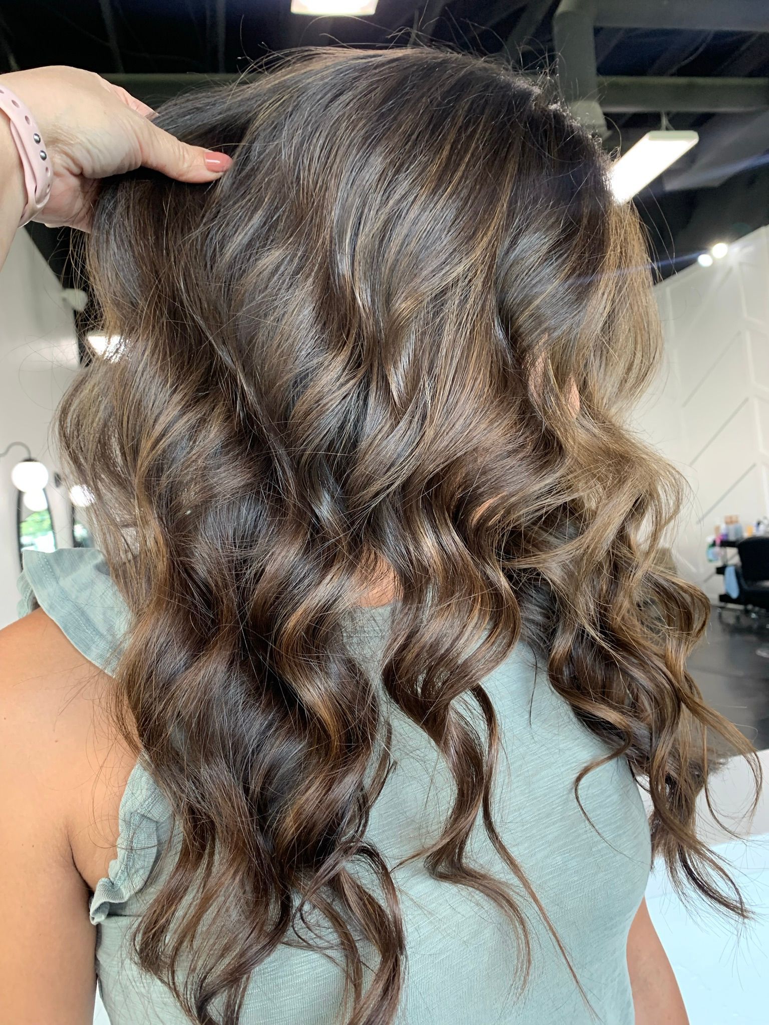A woman is getting her hair done at a salon.