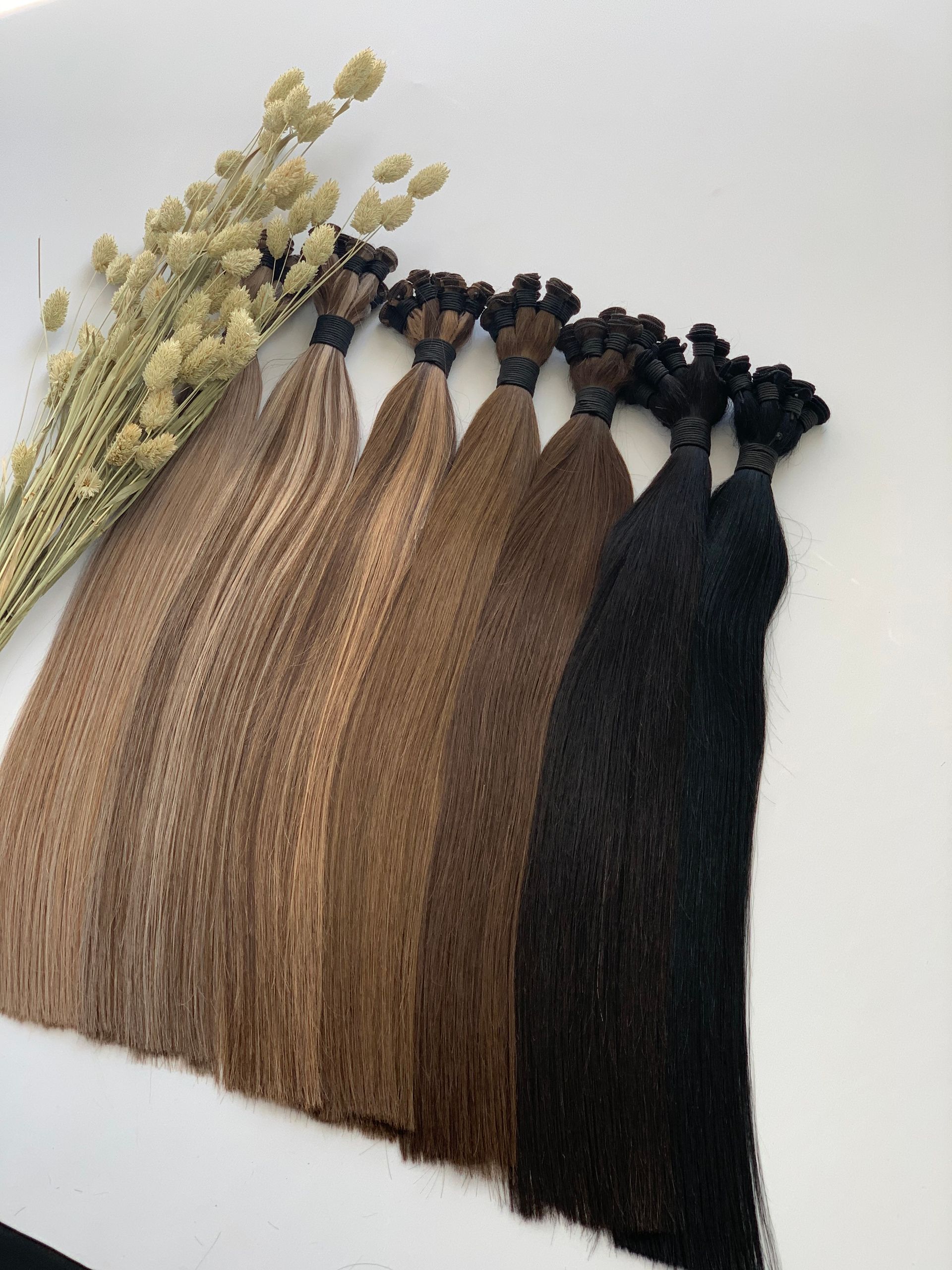 Bundles of hair in various brown shades.