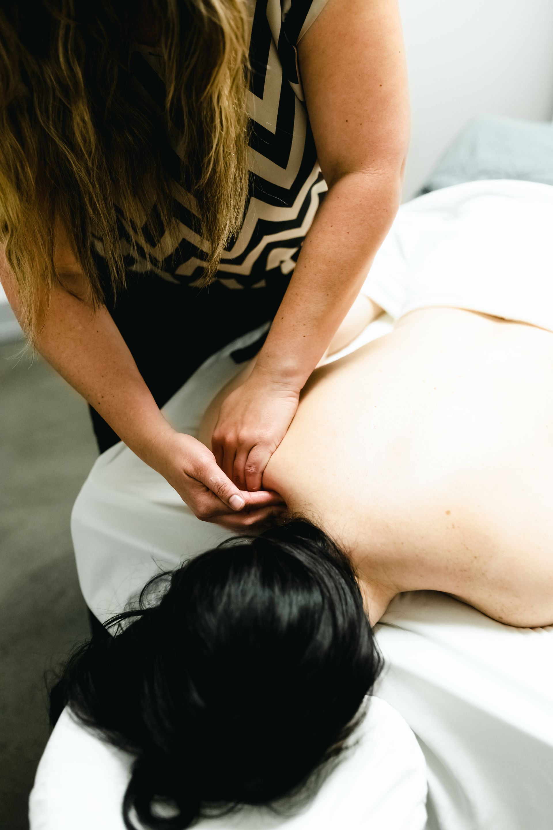 Picture of a woman getting a massage as part of a package of spa services she acquired Picture of a woman getting a massage as part of a package of spa services she acquired