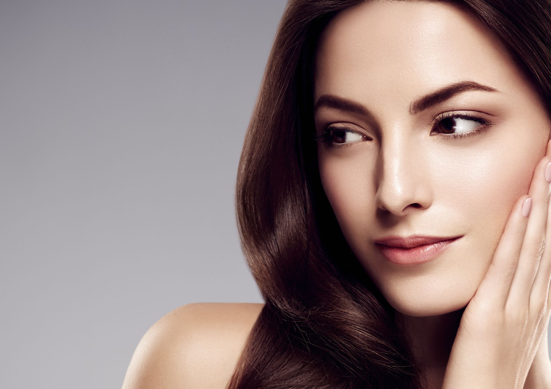 Beautiful girl with long wavy hair, showcasing expert results at a hair coloring salon.