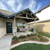 A house with a covered patio in front of it.