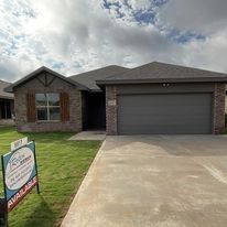 A house with a for sale sign in front of it.